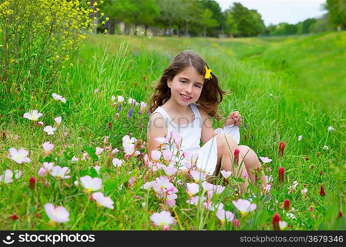 beautiful children girl on spring meadow with poppy flowers