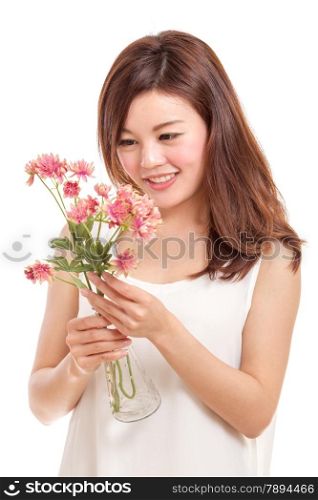 Beautiful Chinese woman with pink flowers in a vase