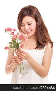 Beautiful Chinese woman with pink flowers in a vase