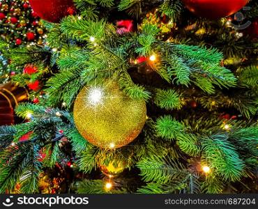 Beautiful Christmas background - shiny baubles on a background of blurred lights on a Christmas tree with bokeh effect.