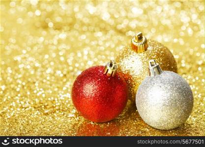 Beautiful christmas balls on abstract glitter background close-up