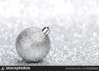 Beautiful christmas decoration ball on silver shiny background