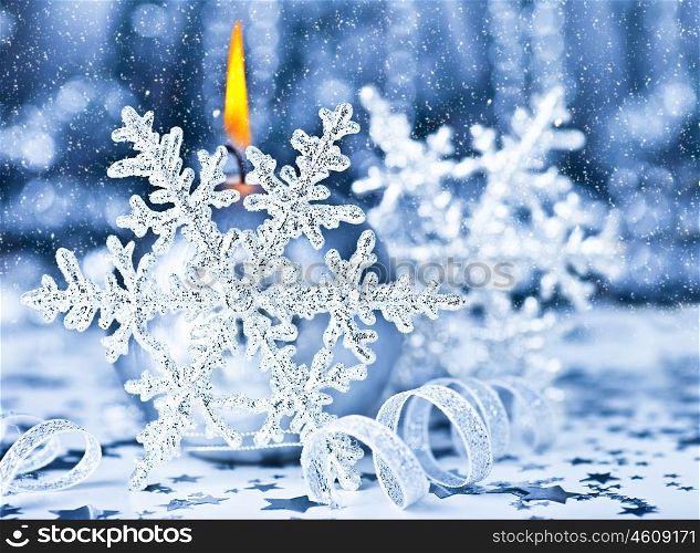 Beautiful Christmas decoration, blue holiday background with candle light &amp; snowflake, winter holidays celebration, soft focus