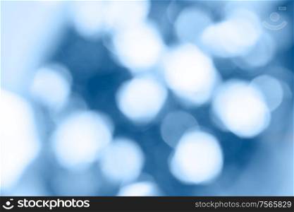 Beautiful Christmas defocused light background. Abstract classic blue glitter bokeh and scattered sparkles. Beautiful Christmas light background. Abstract glitter bokeh and scattered sparkles in gold, on black