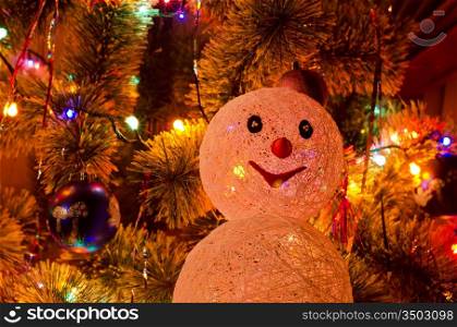 Beautiful Christmas fur-tree decorated with snowman toy
