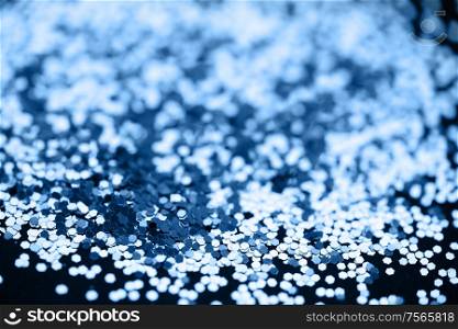 Beautiful Christmas light background. Abstract classic blue glitter bokeh and scattered sparkles, on black. Beautiful Christmas light background. Abstract glitter bokeh and scattered sparkles in gold, on black