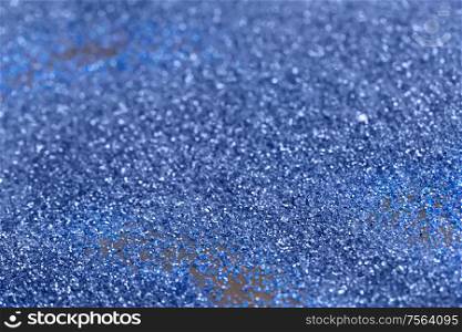 Beautiful Christmas multicolored light background. Abstract classic blue glitter bokeh and scattered sparkles. Beautiful Christmas light background. Abstract glitter bokeh and scattered sparkles in gold, on black