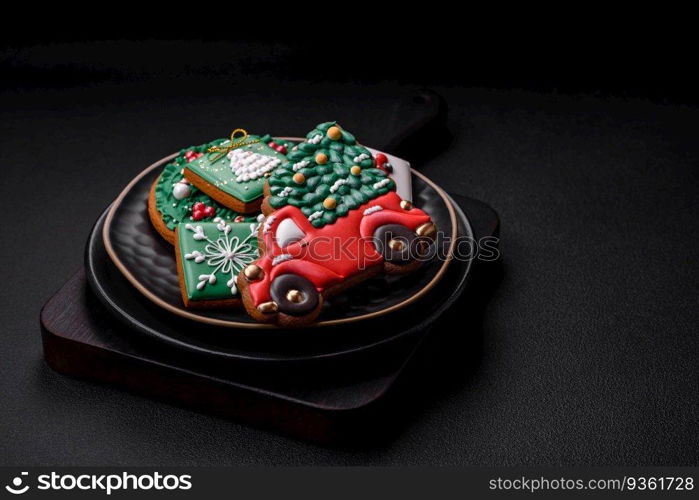 Beautiful Christmas or New Year colorful homemade gingerbread cookies on a ceramic plate on a dark concrete background. Beautiful Christmas or New Year colorful homemade gingerbread cookies