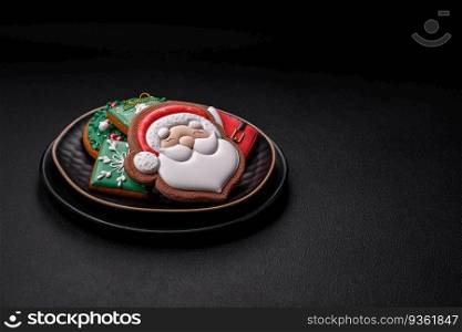 Beautiful Christmas or New Year colorful homemade gingerbread cookies on a ceramic plate on a dark concrete background. Beautiful Christmas or New Year colorful homemade gingerbread cookies