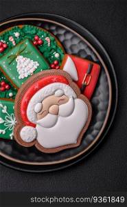 Beautiful Christmas or New Year colorful homemade gingerbread cookies on a ceramic plate on a dark concrete background. Beautiful Christmas or New Year colorful homemade gingerbread cookies