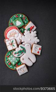 Beautiful Christmas or New Year colorful homemade gingerbread cookies on a dark concrete background