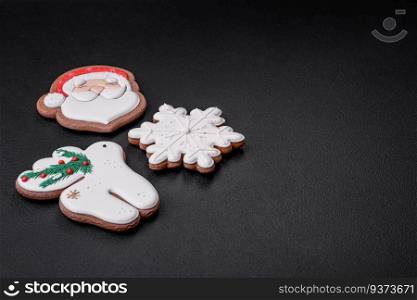 Beautiful Christmas or New Year colorful homemade gingerbread cookies on a dark concrete background