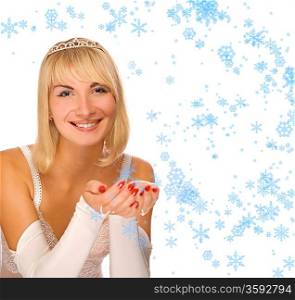 Beautiful Christmas princess playing with snowflakes