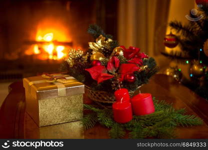 Beautiful Christmas tree and stack of presents in front of burning fireplace