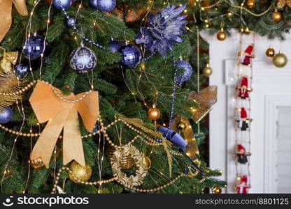 Beautiful Christmas tree with garlands, balls and toys. Preparing your home for the new year