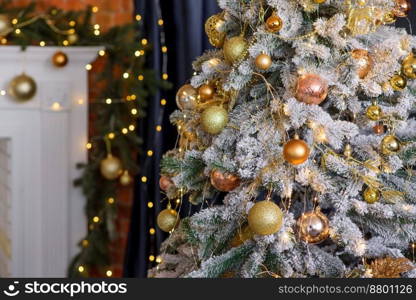 Beautiful Christmas tree with garlands, balls and toys. Preparing your home for the new year