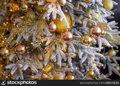 Beautiful Christmas tree with garlands, balls and toys. Preparing your home for the new year