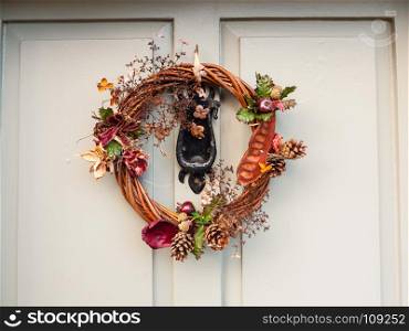 beautiful christmas wreath on front of door hanging close up; essex; england; uk