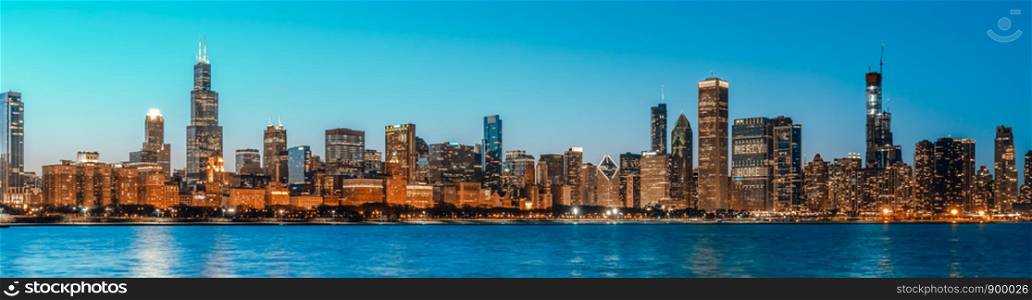 Beautiful cityscape panorama view of buildings in Chicago downtown district at twilight blue hour, banner size. America tourism, travel destination, tourist attraction, or American city life concept