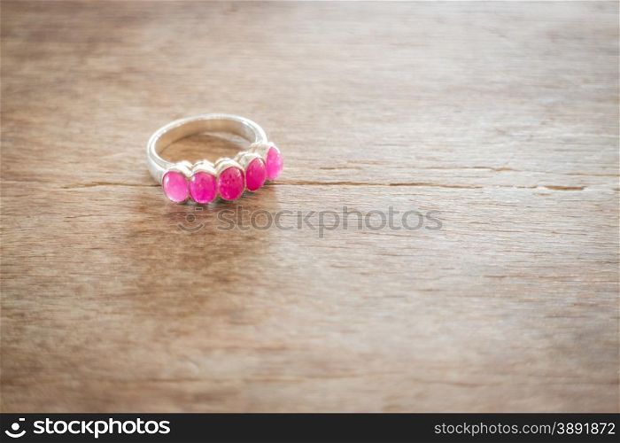 Beautiful classic ruby ring on wooden table, stock photo