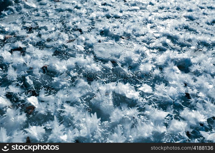 Beautiful closeup of big icy snowflakes on frosted stream