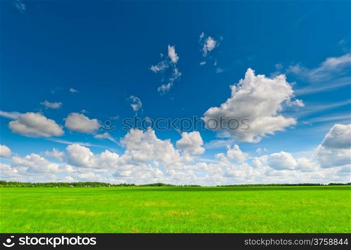 beautiful clouds cast shadows on the green field