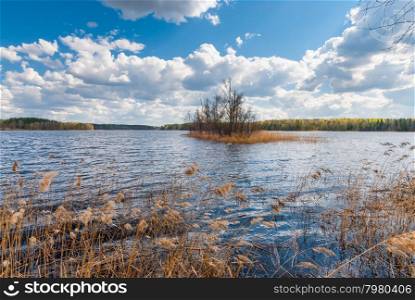 beautiful clouds over the forest lake in autumn day