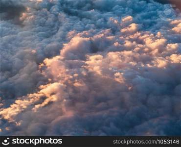 Beautiful clouds scape from airplane window at sunset.