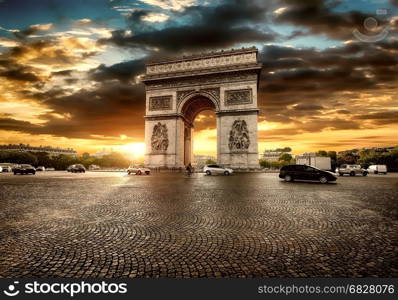 Beautiful cloudy sunset over Arc de Triomphe in Paris, France