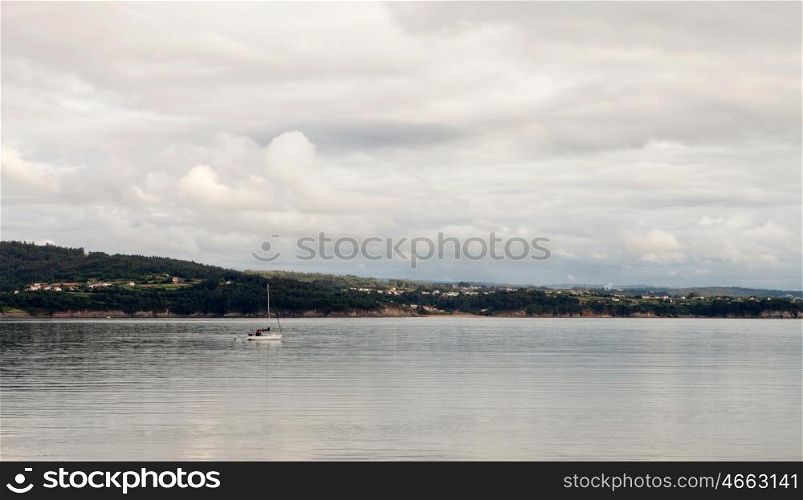 Beautiful coastal landscape with a boat on the calm sea