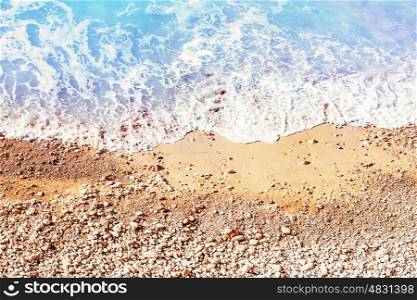 Beautiful coastline, sandy beach with pebbles washed by the sea shore waters, tropical resort background, summer vacation concept&#xA;