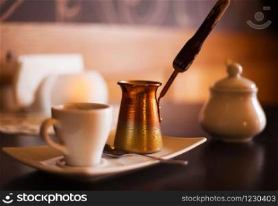 beautiful coffee house in an interesting cozy design-on the table a candle, coffee and turka.. beautiful coffee house in an interesting cozy design-on the table a candle, coffee and turka