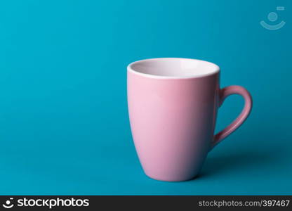 beautiful coffee pink cup on blue background