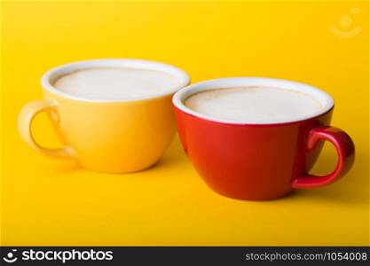 beautiful coffee yellow and red cup with cappuccino on yellow background