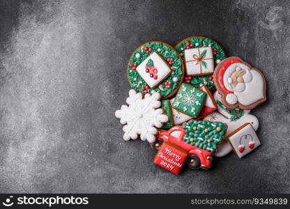 Beautiful colored Christmas gingerbread cookies for the design and decoration of the festive table on a textured concrete background