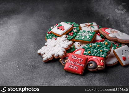 Beautiful colored Christmas gingerbread cookies for the design and decoration of the festive table on a textured concrete background