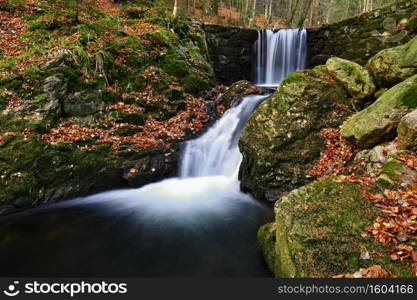 Beautiful colorful background with river and stones in autumn time. White Opava Waterfalls - Jeseniky Mountains - Czech Republic.