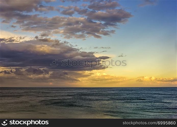 Beautiful colorful clouds over the sea. Amazing sky after sunset.