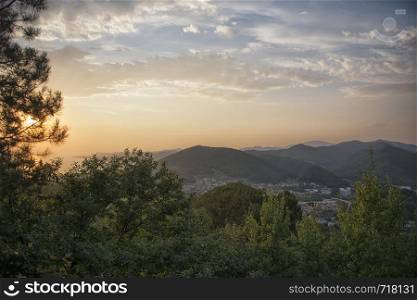 Beautiful colorful evening scenery of the mountain and sea bay view. Coast line of the black sea at dawn with a picturesque orange sunset beside pine tree. Agoy, Tuapse region, Russia.. Beautiful colorful evening scenery of the mountain and sea bay view. Tuapse region, Russia.