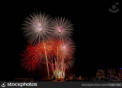 Beautiful colorful fireworks display on the sea beach, Amazing holiday fireworks party or any celebration event in the dark sky.. Beautiful colorful fireworks display on the sea beach.