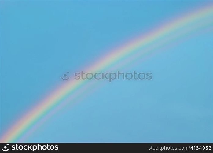 Beautiful colorful rainbow in the blue sky