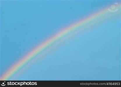 Beautiful colorful rainbow in the blue sky