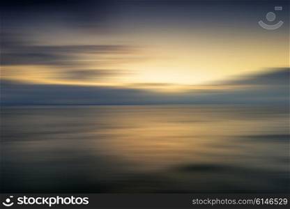 Beautiful colorful sunrise landscape over calm sea with blur effect added