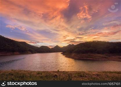 Beautiful colorful sunset sky in mountain at lake