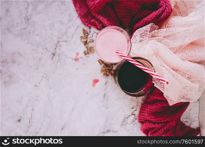 Beautiful composition in pink and white of milkshake and red tea