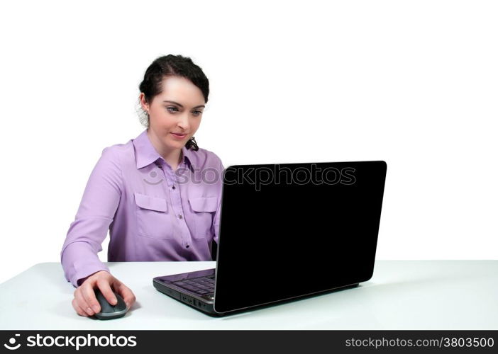 Beautiful computer savvy young woman using a laptop . Sunset over a Lake