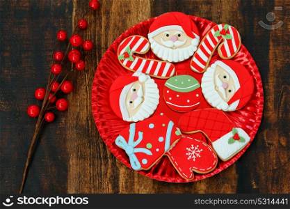 Beautiful cookies on a red plate on a wooden table