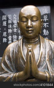 Beautiful copper Buddha statue at a shrine near Senso-ji Temple, Asakusa, Tokyo, Japan