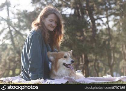beautiful corgi dog and girl on the lawn in the park
