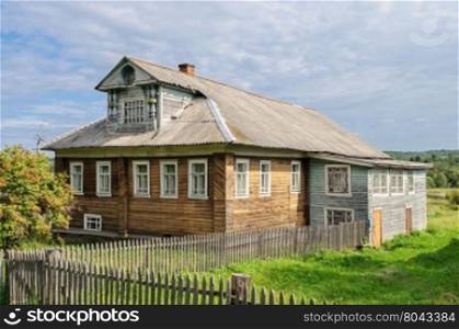 Beautiful country wooden house with mansard, Russia. Summer sunny day